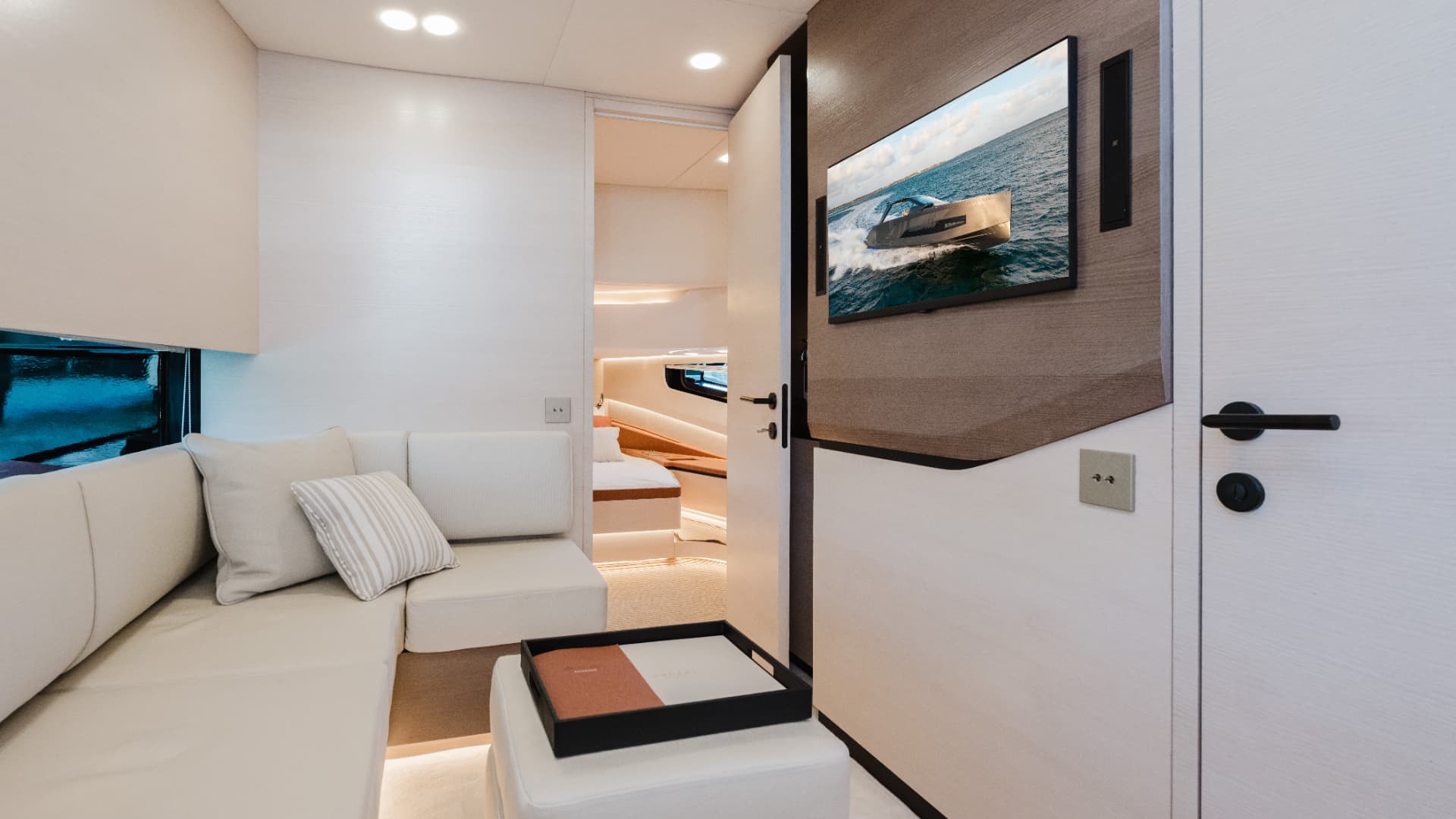 Manari 52 below deck lounge with seating and entertainment screen